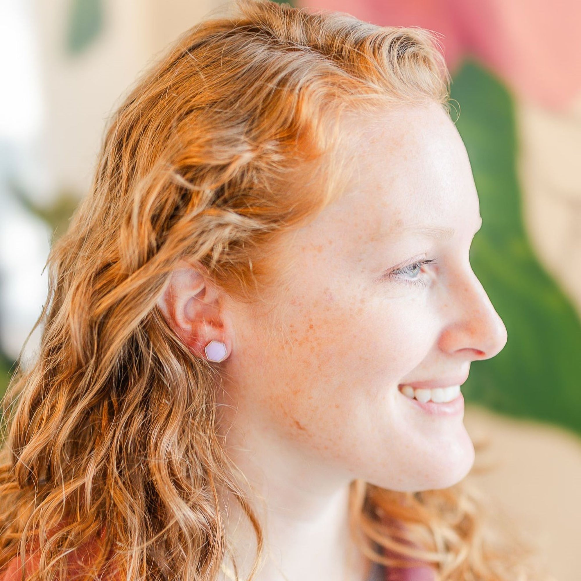clay hexagon studs lavender on smiling model