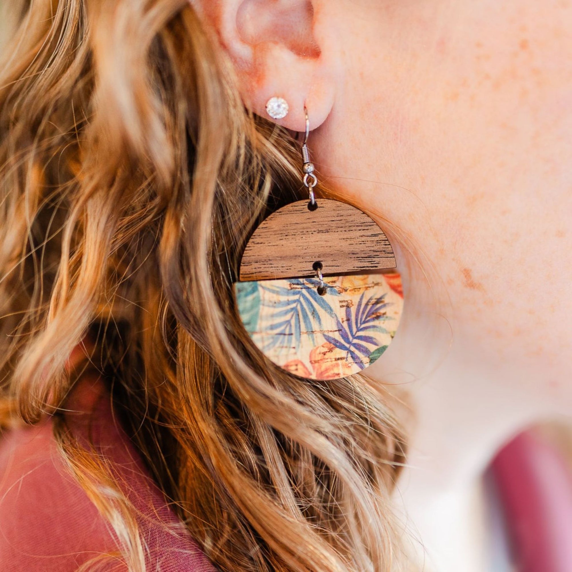 close up of everly painted canopy cork and wood earrings on model