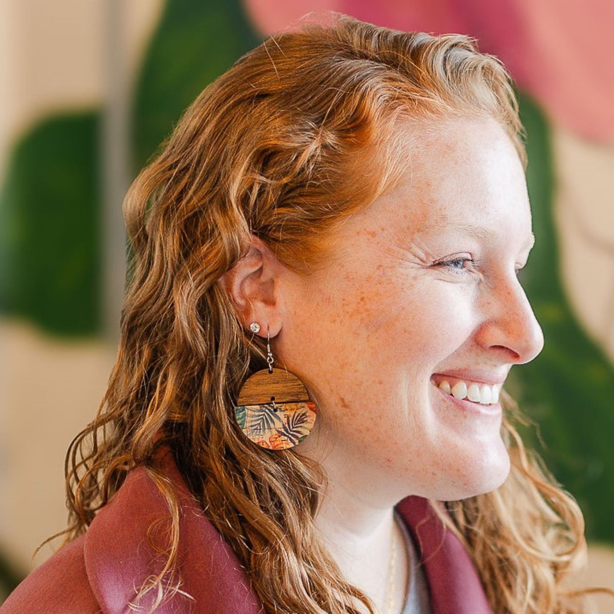 smiling model wearing everly painted canopy cork and wood earrings