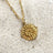 Journey gold necklace on sand closeup