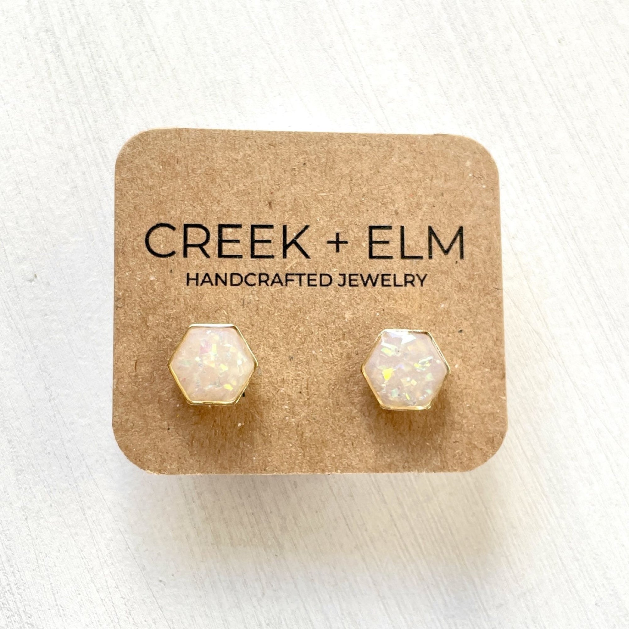Opal clay hexagon studs on plain background