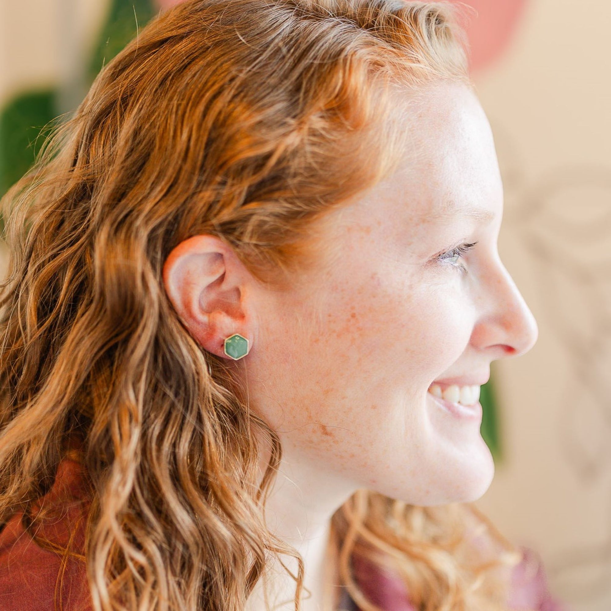clay hexagon studs green onyx on smiling model