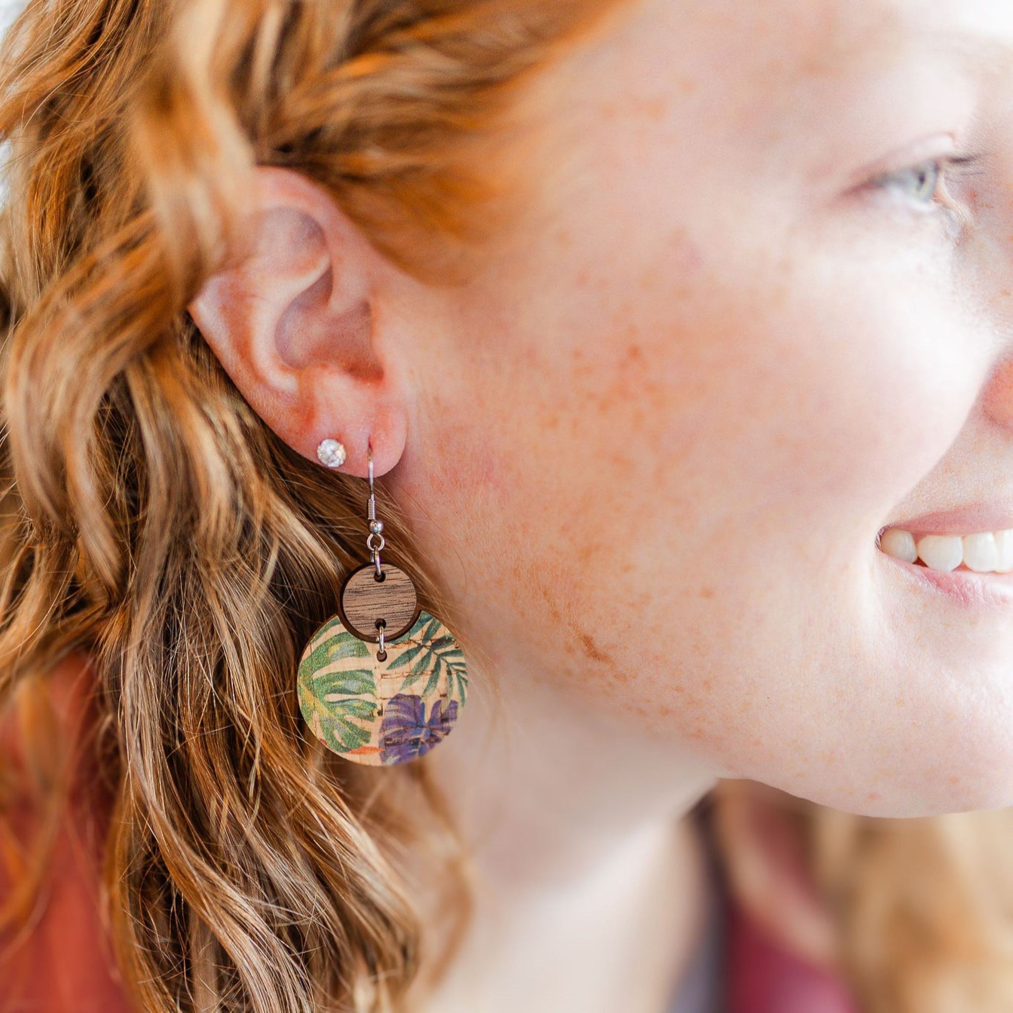 cora cork and wood painted canopy earrings on smiling model