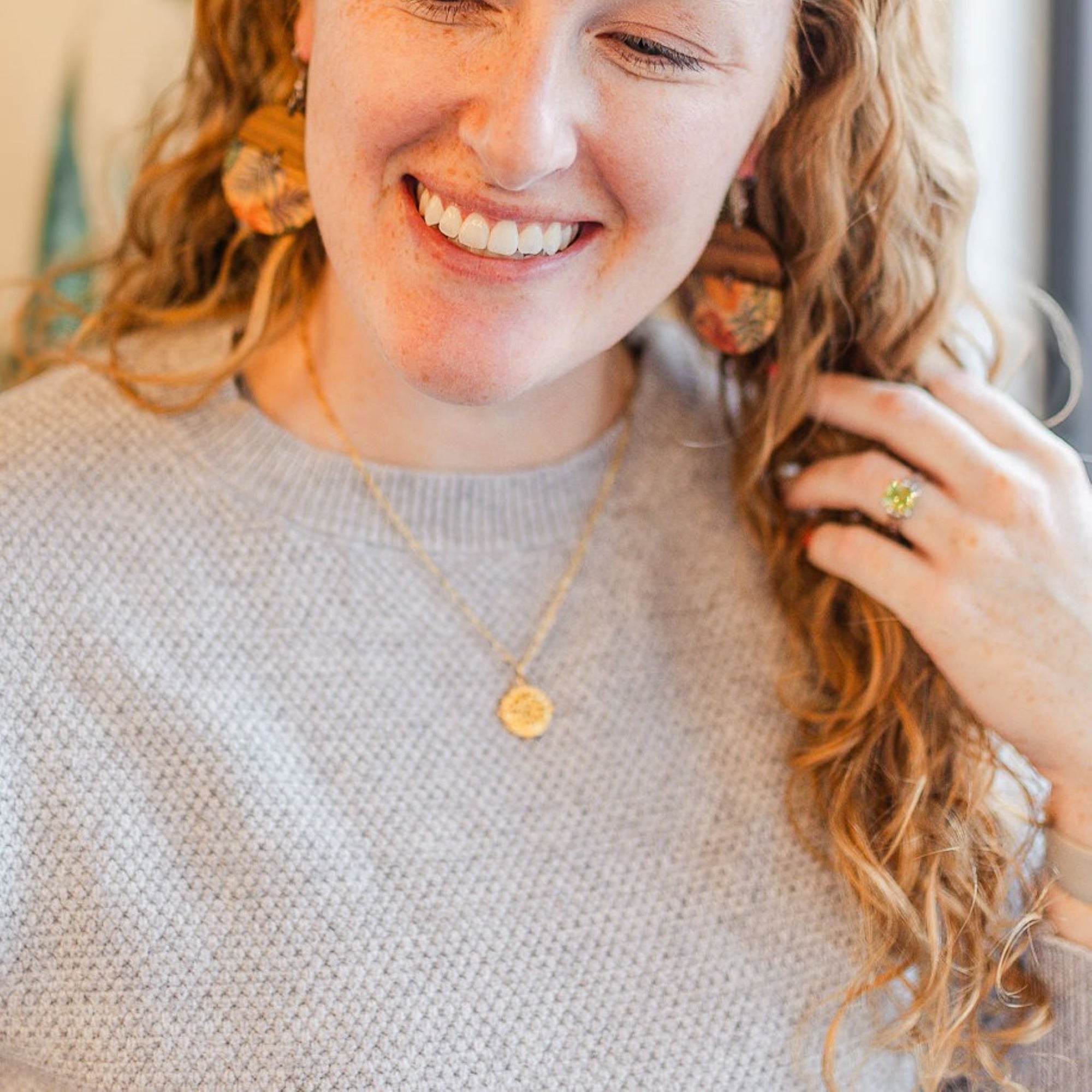 journey gold necklace on smiling model