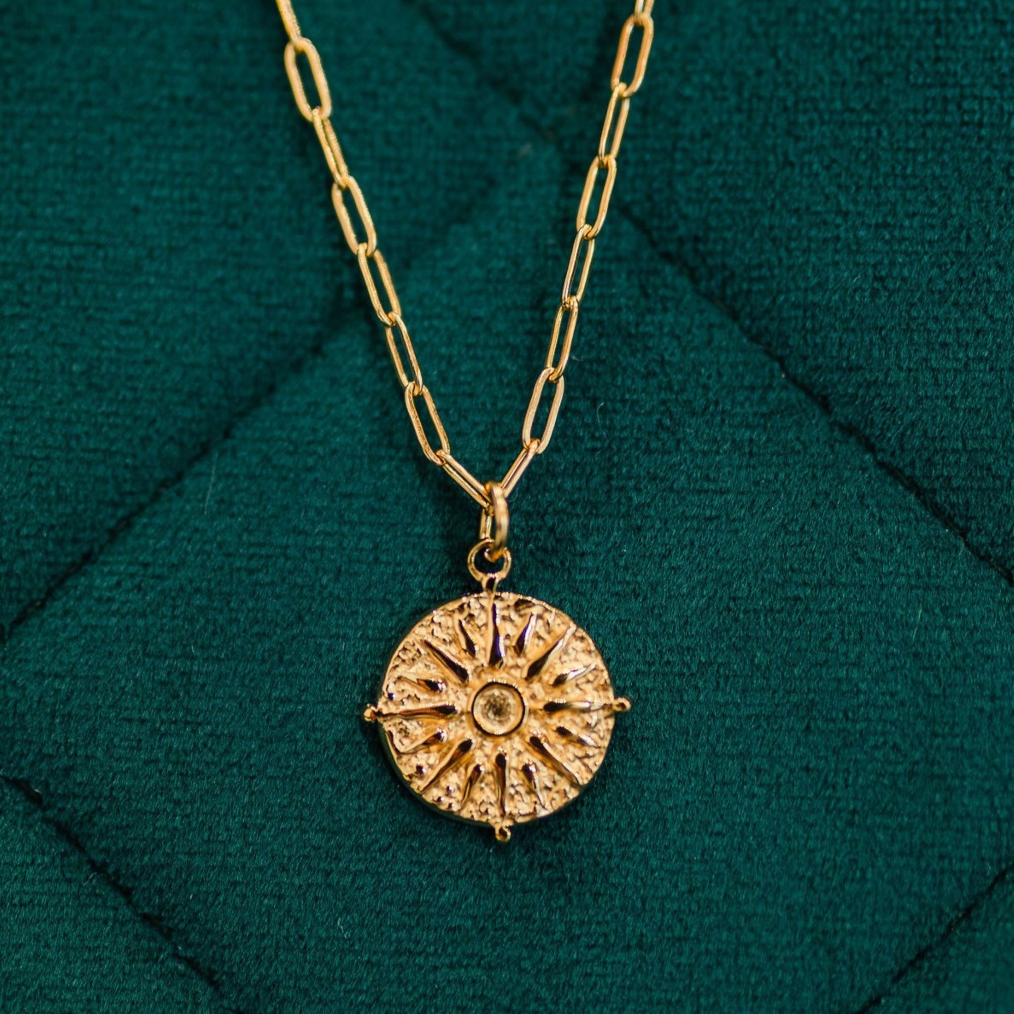 journey gold necklace on deep green background