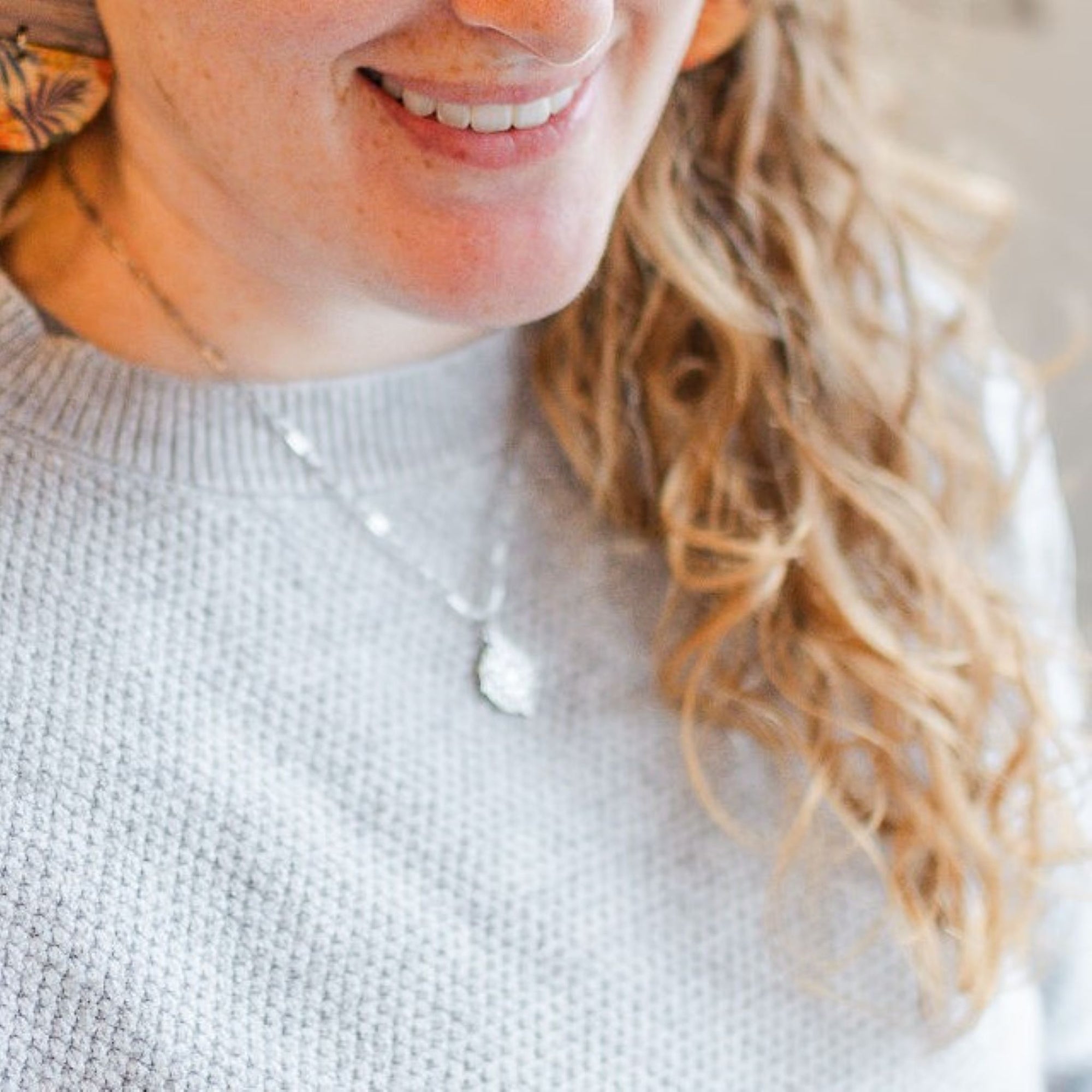 journey stainless steel silver necklace on smiling model