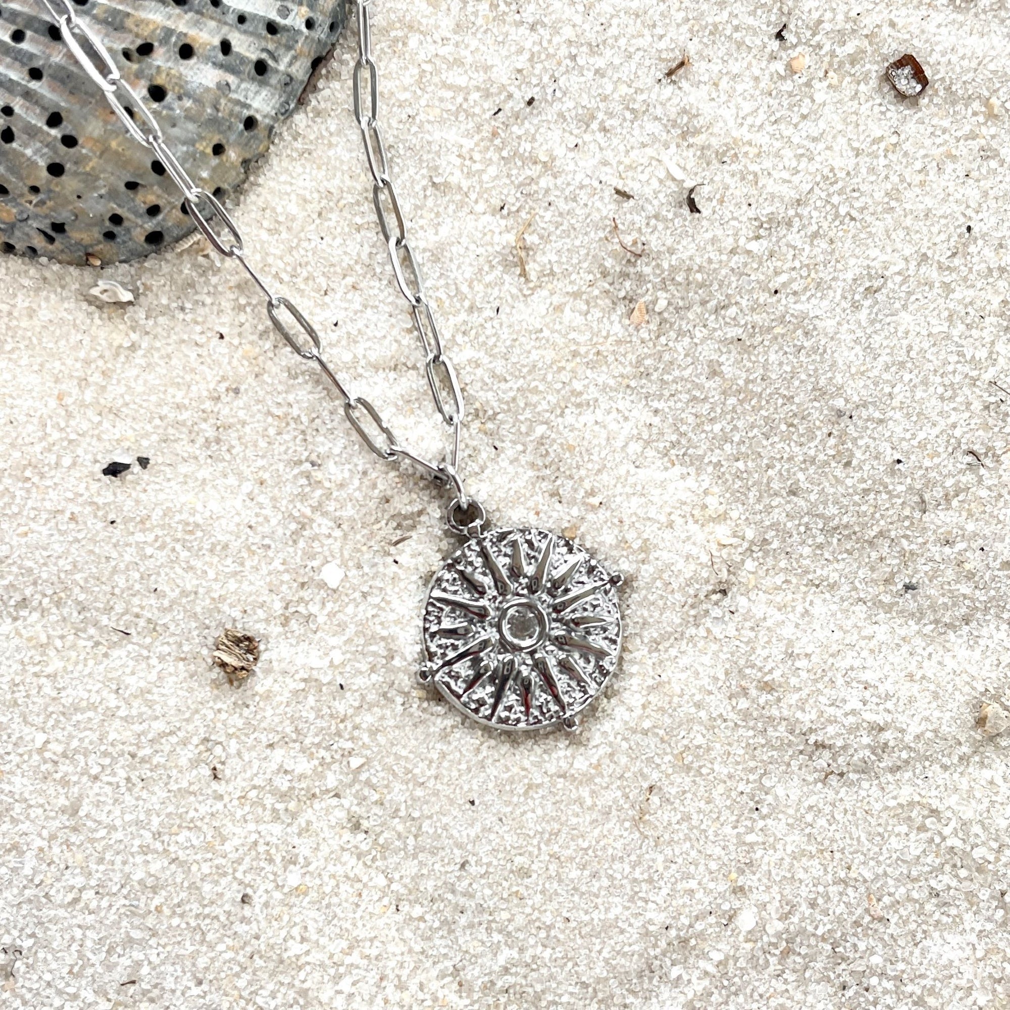 journey stainless steel silver necklace on sand with seashell