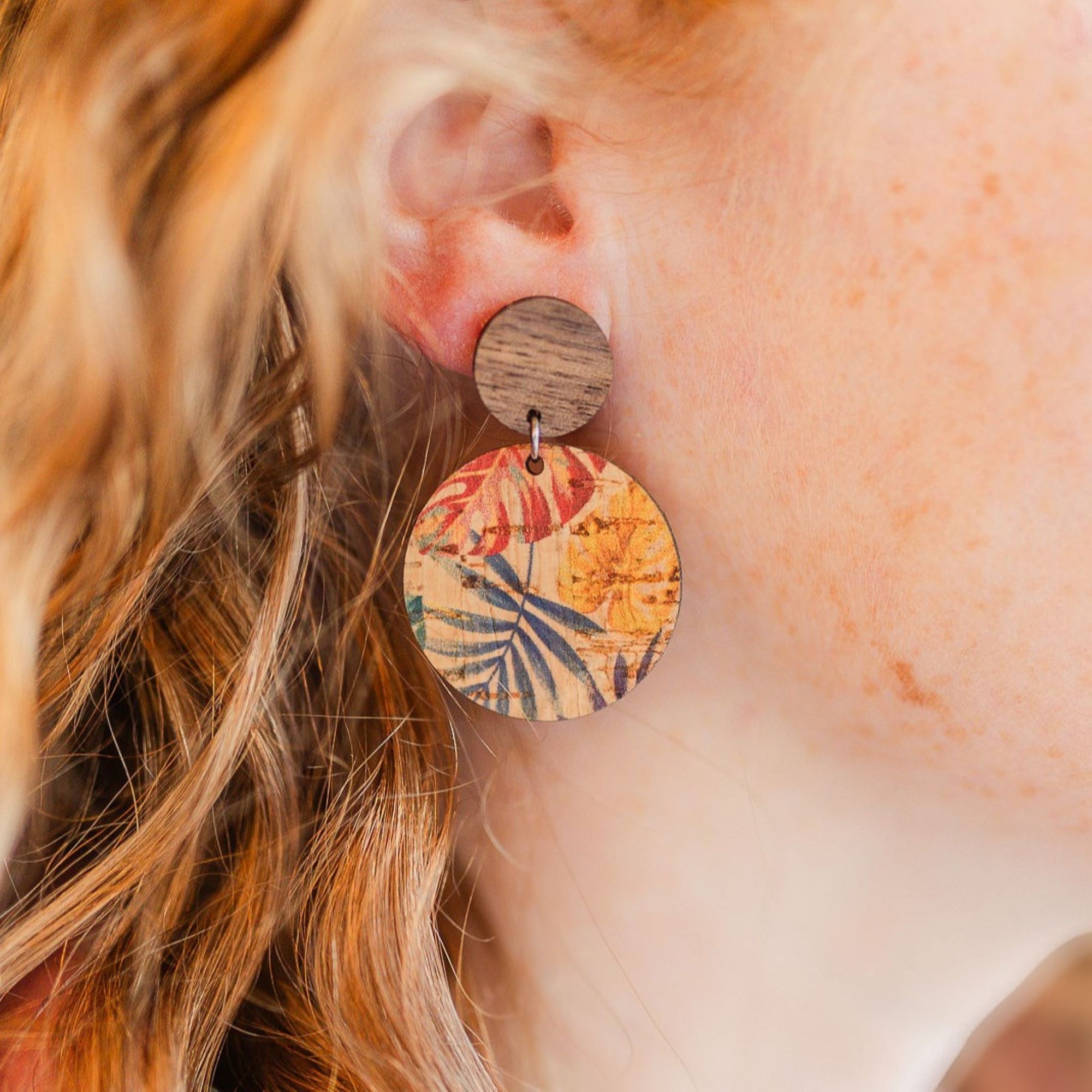 liyra cork and wood earrings in painted canopy pattern close up on ear