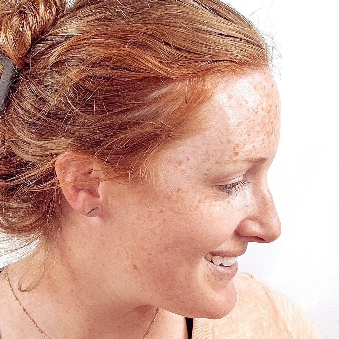 Side view of a woman wearing the Silver stainless steel bar stud earrings 