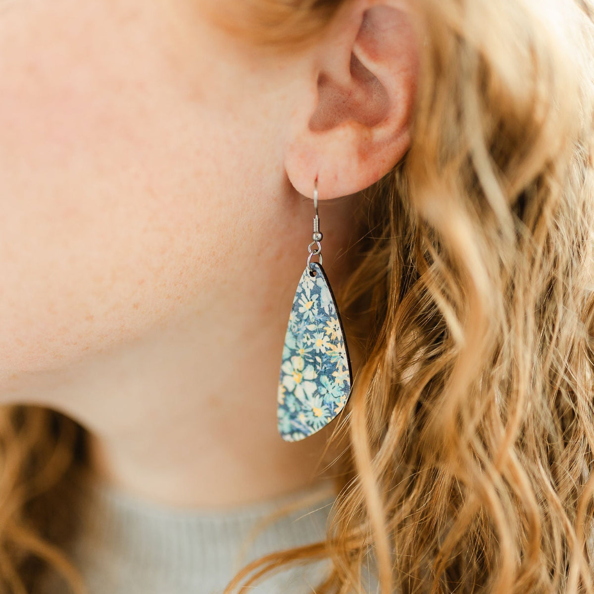 Close up of the Eliza blue floral cork teardrop earrings 