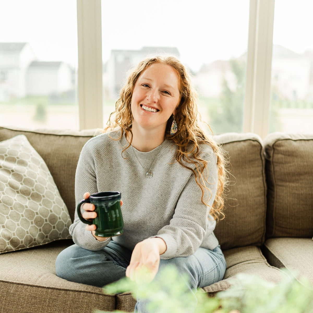 Woman wearing the Eliza heirloom floral cork teardrop earrings