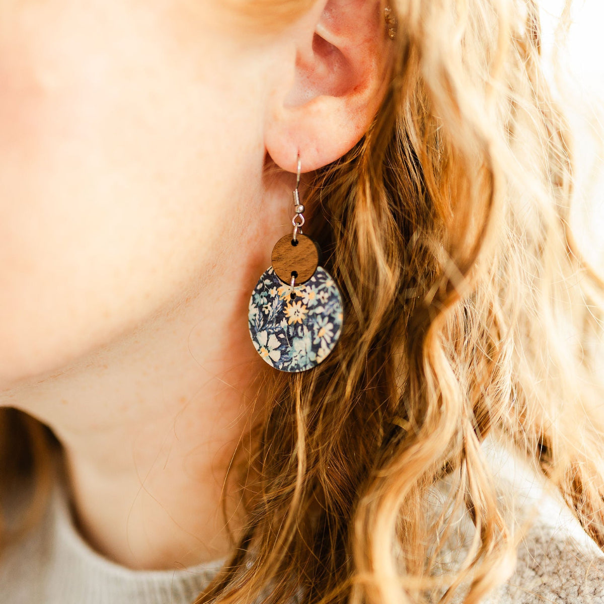Close up shot of the Cora Blue Floral cork and walnut earrings 