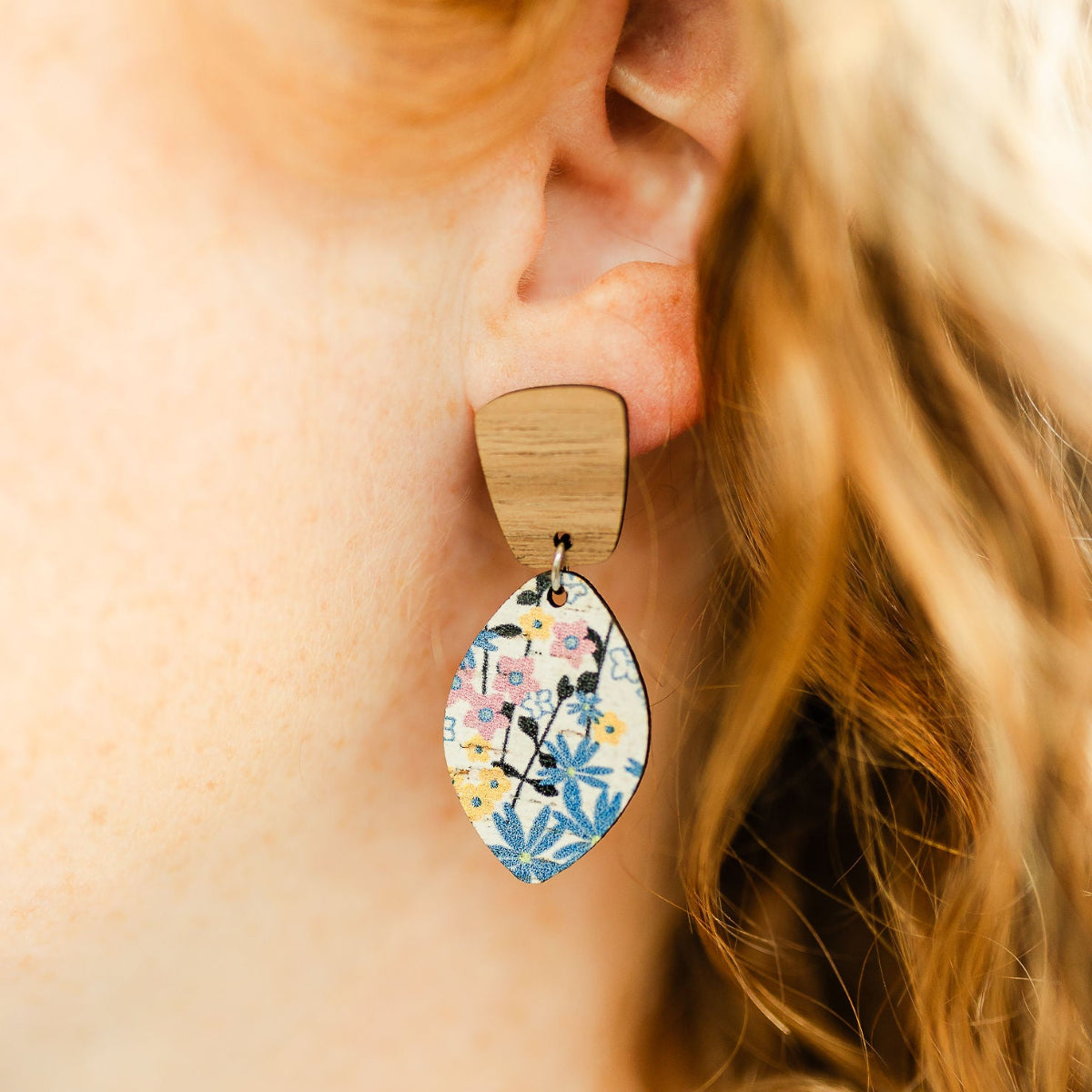 Close up of the Lightweight leaf-shaped cork and walnut earrings with floral pattern