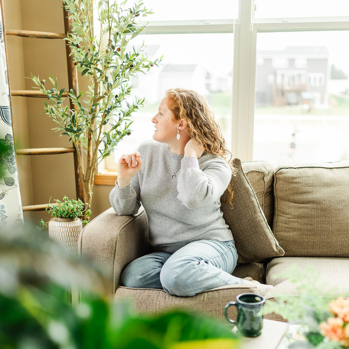 Woman wearing the Wildflower cork and walnut leaf earrings