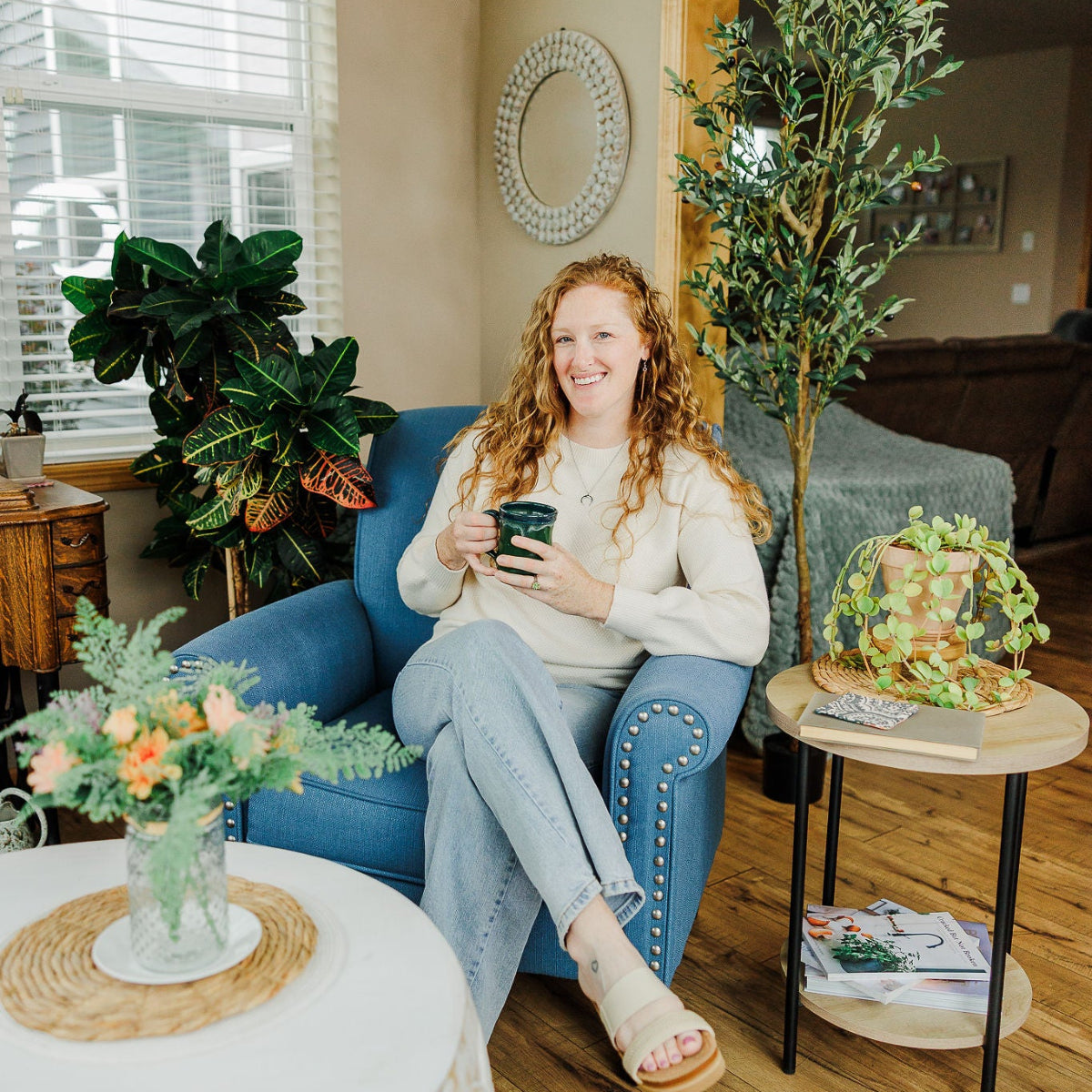 Woman sitting on a couch while holding a mug
