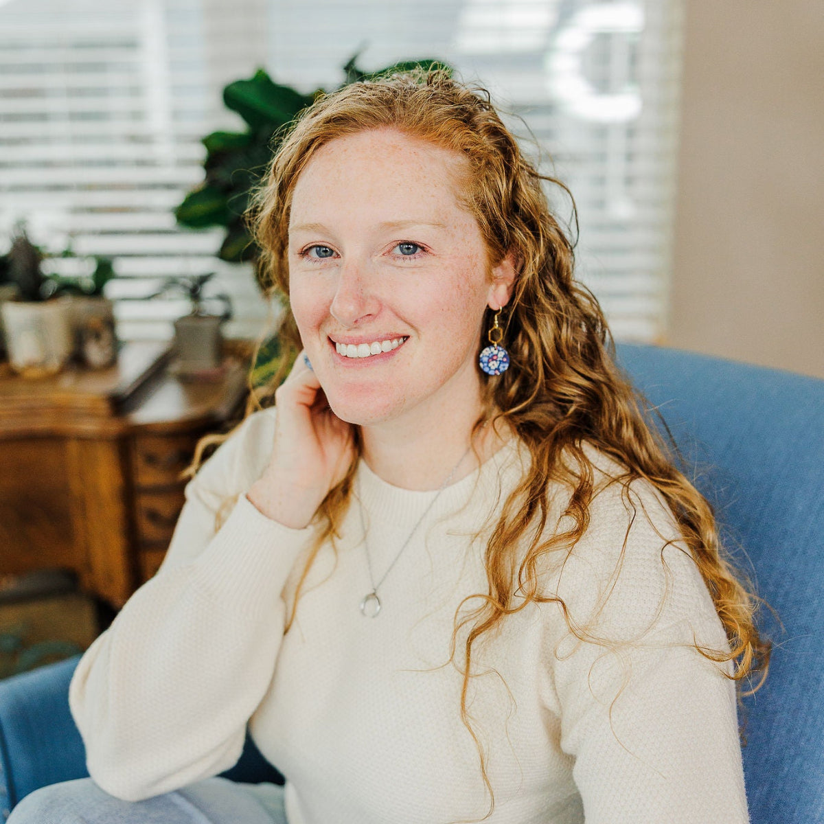 Woman sitting on couch while smiling