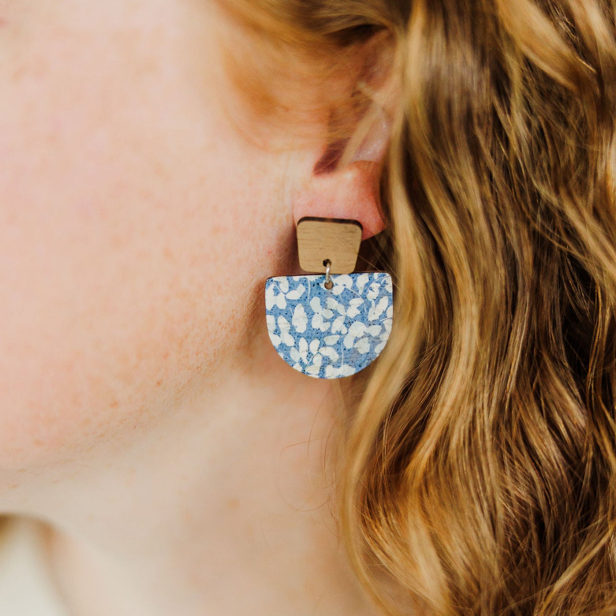 close up look of a blue dotted earring