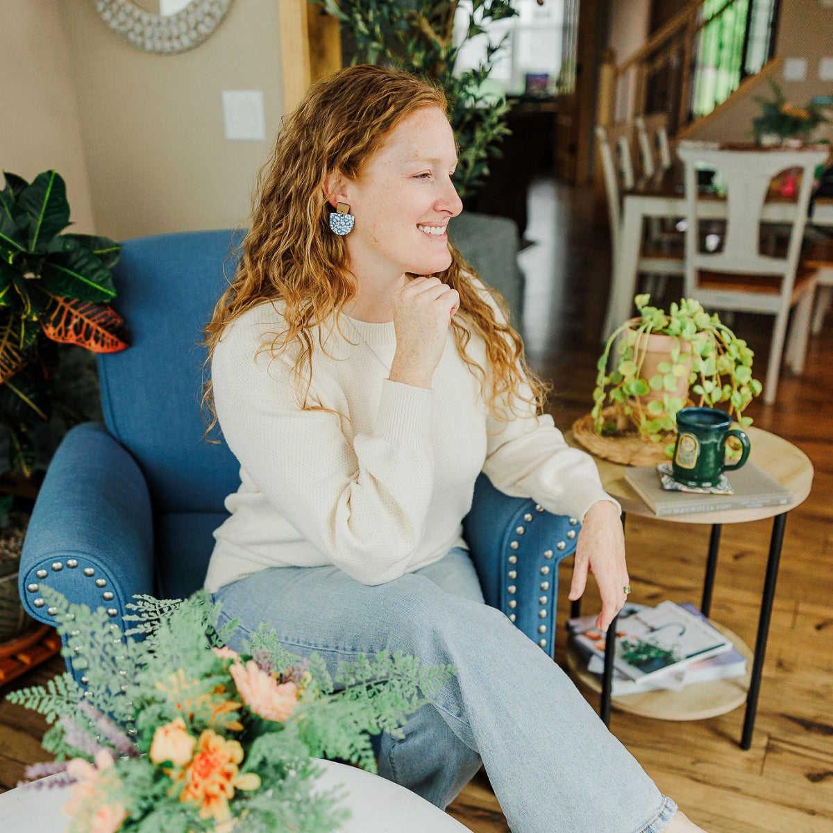 woman on couch modeling for creek+elm earring
