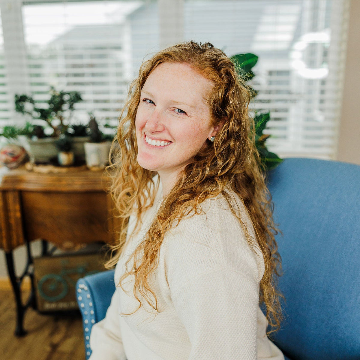 Woman on couch wearing the creek+elm stud