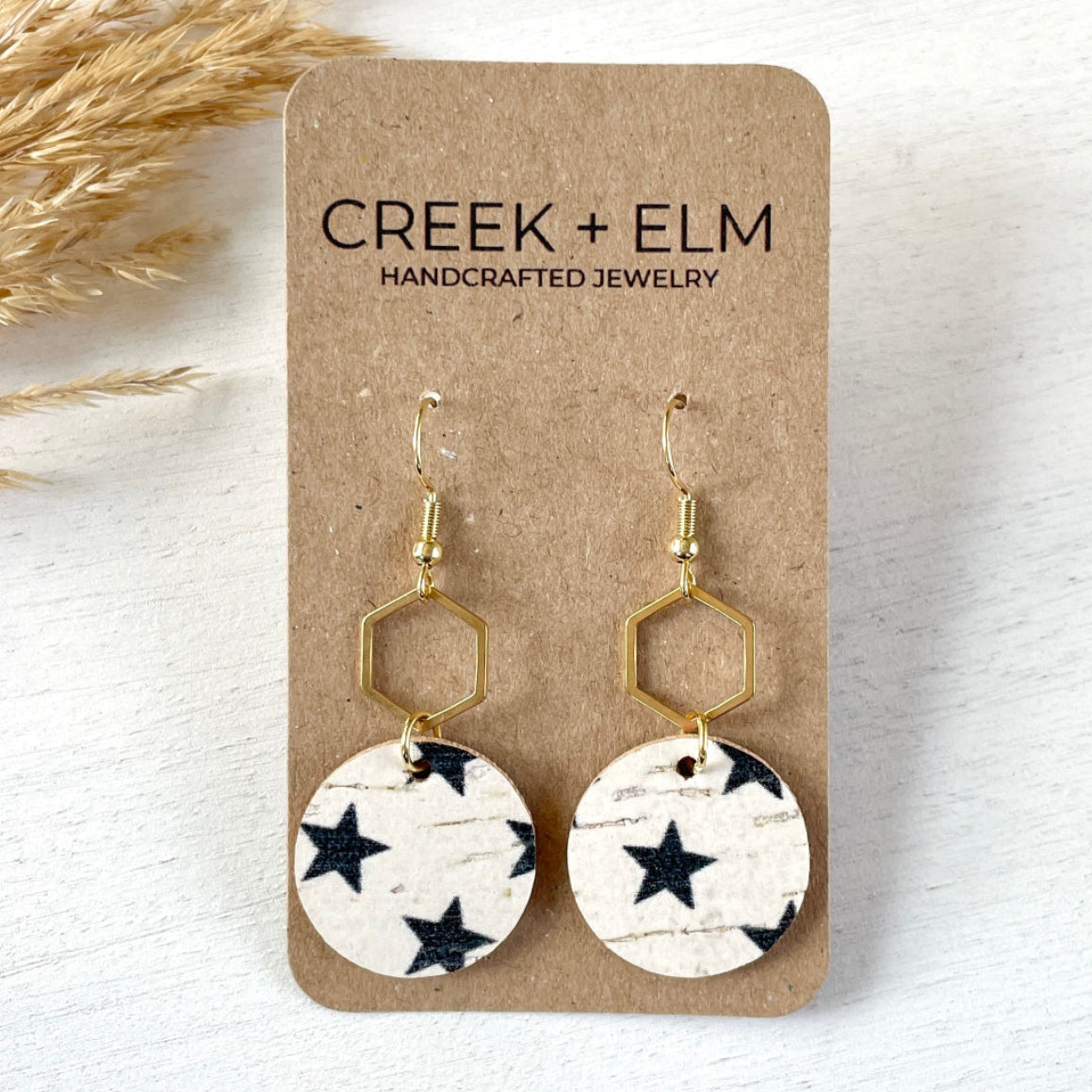 Gold Elizabeth blue stars cork hexagon earrings on Creek+Elm Packaging