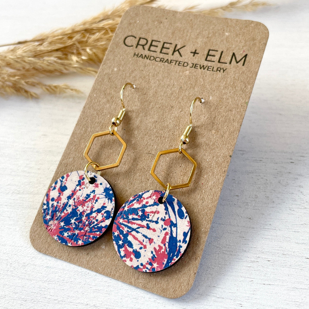 Gold Elizabeth star spangled cork and hexagon earrings on Creek+Elm Packaging