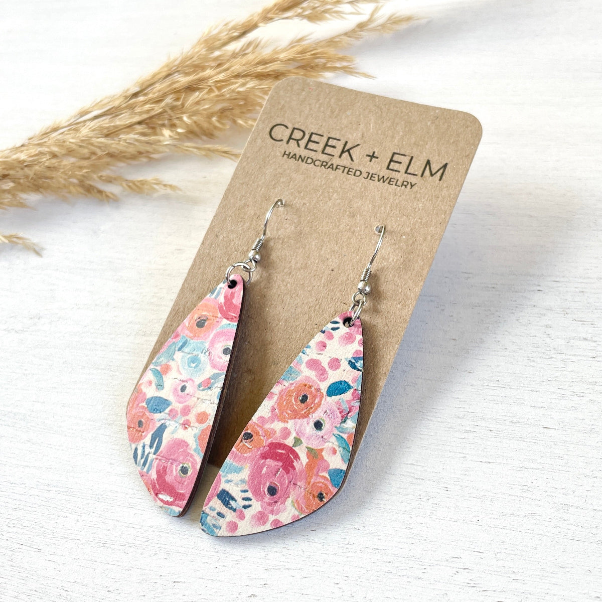 Side view of the Eliza Summer Garden cork teardrop earrings on packaging 