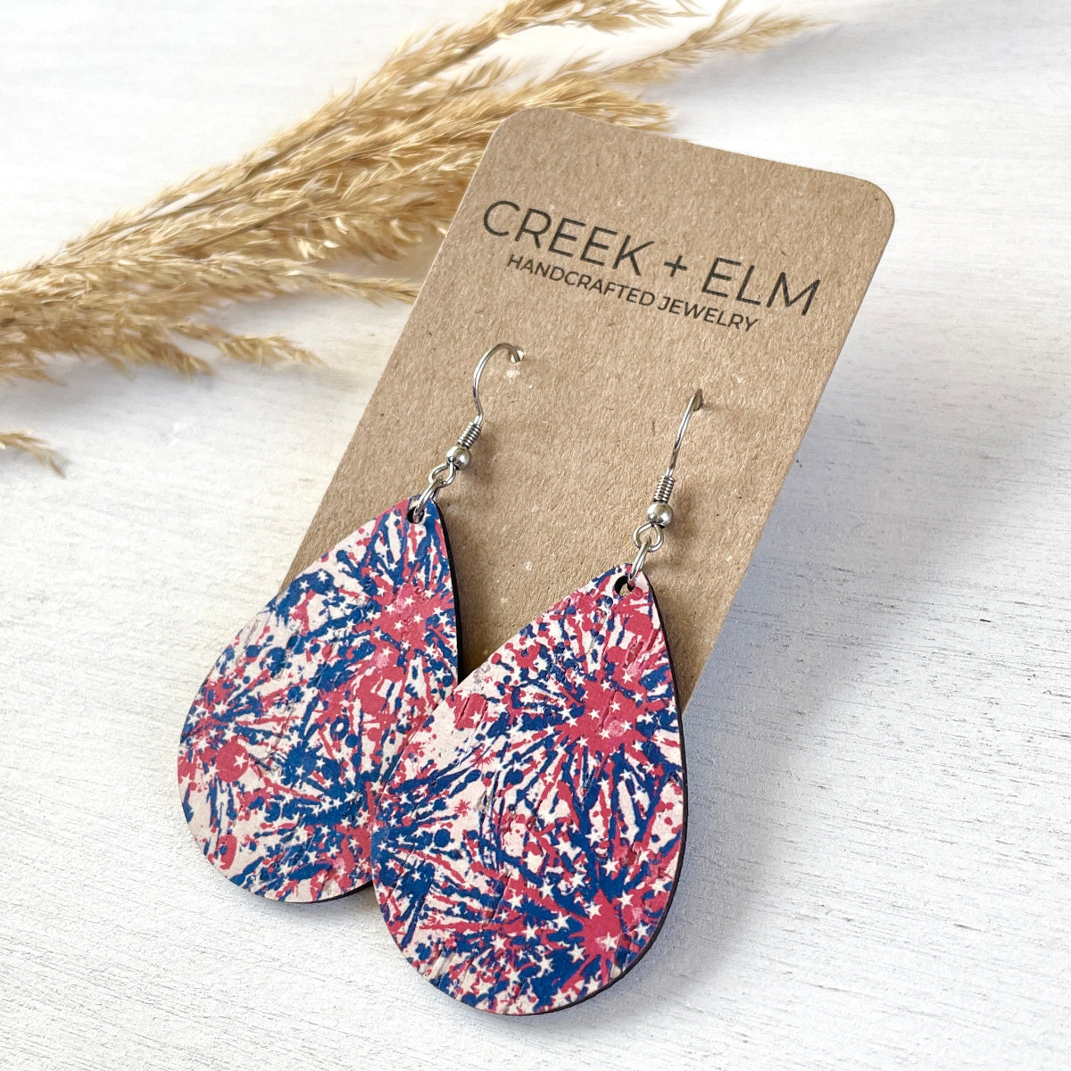 Silver Kendra star spangled cork teardrop earrings on Creek+Elm Packaging