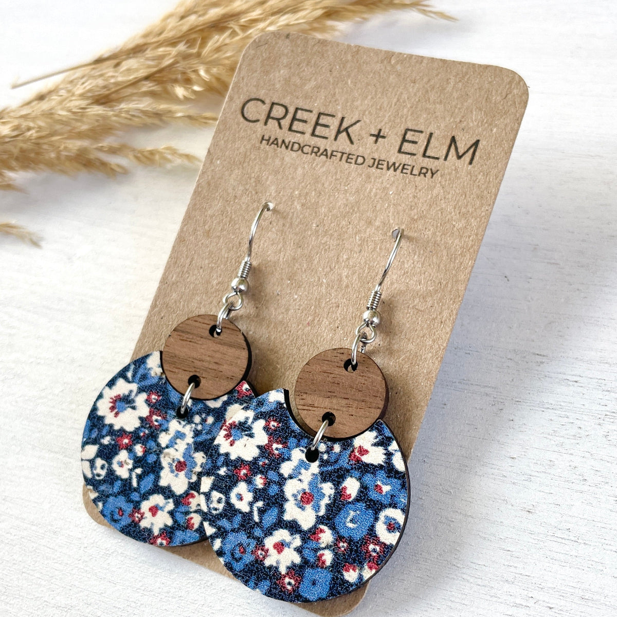 Side view of the Cora Patriotic Poppies cork and walnut earrings on Creek+Elm Packaging