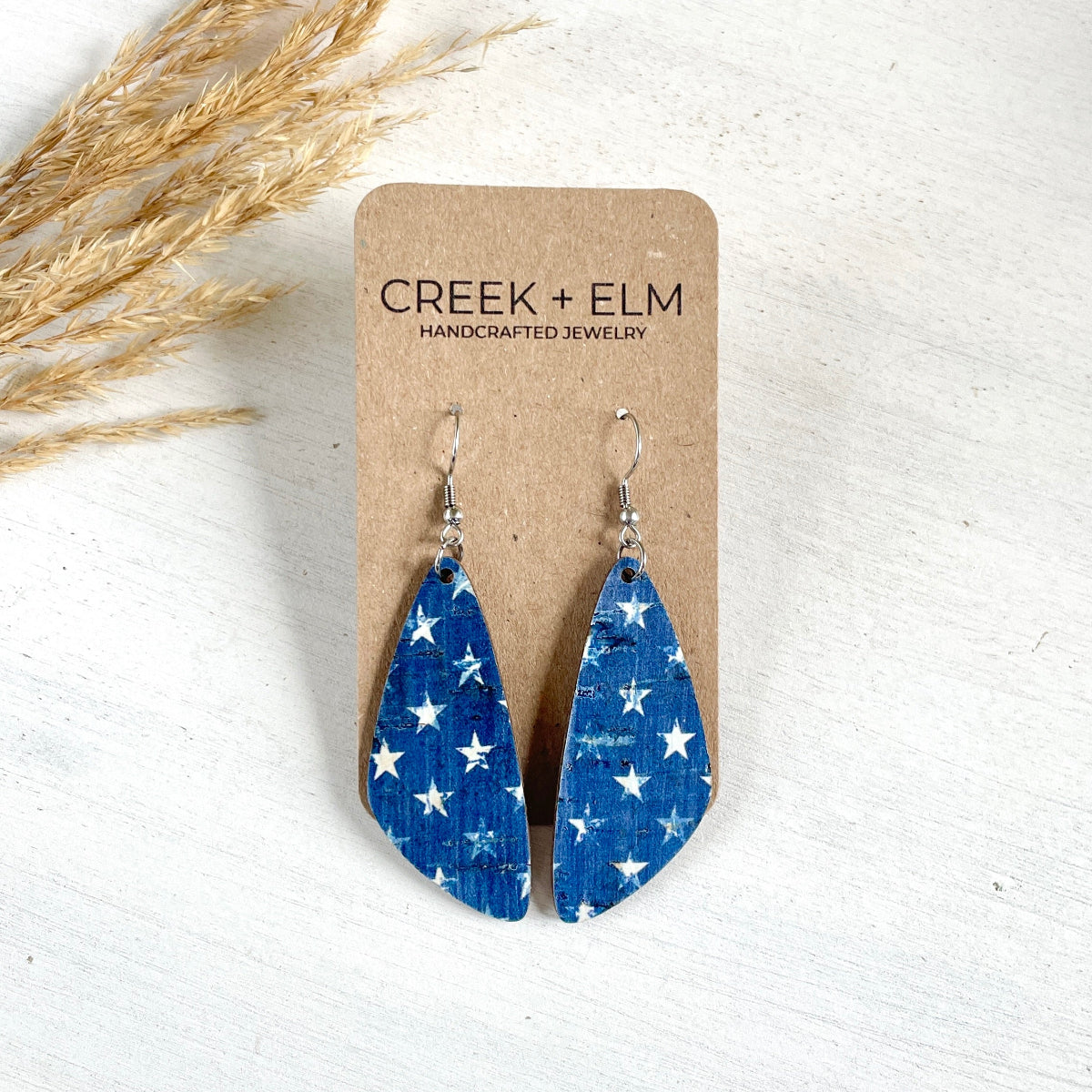 Silver Eliza Denim Stars cork teardrop earrings on Creek+Elm Packaging 
