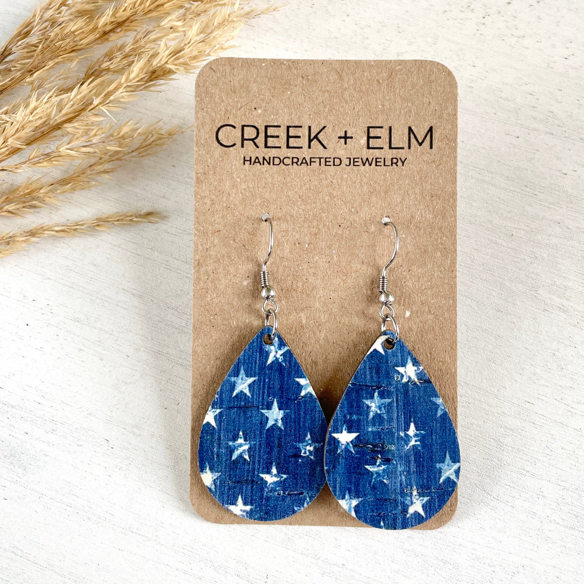 Mini Silver Kendra Denim Stars cork teardrop earrings on Packaging 
