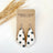 Flat lay photo of earrings displayed on a Creek & Elm packaging