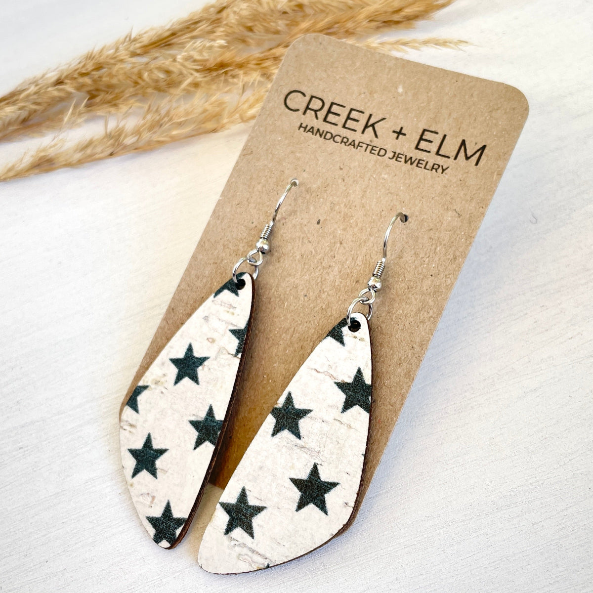 Side Flat lay photo of earrings displayed on a Creek & Elm packaging