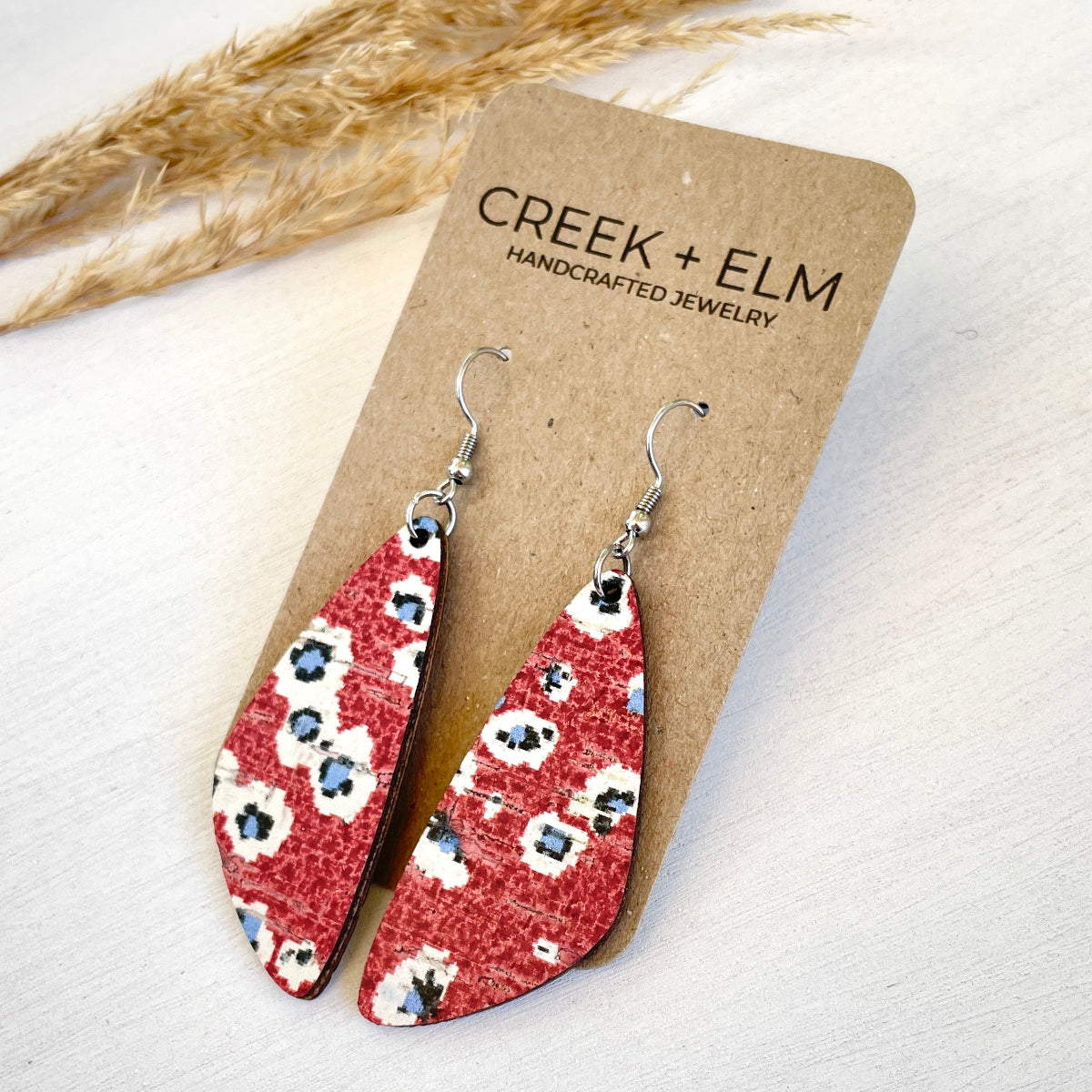Slightly tilted flat lay of the firework-inspired earrings on packaging