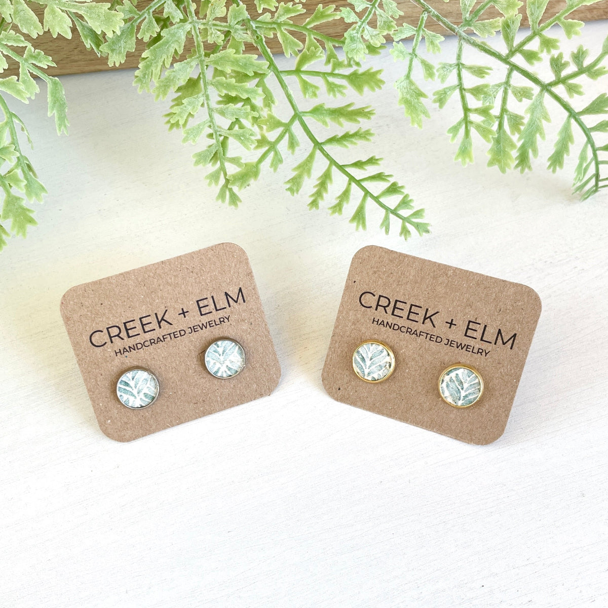 Silver and gold Creek+elm studs on packaging 