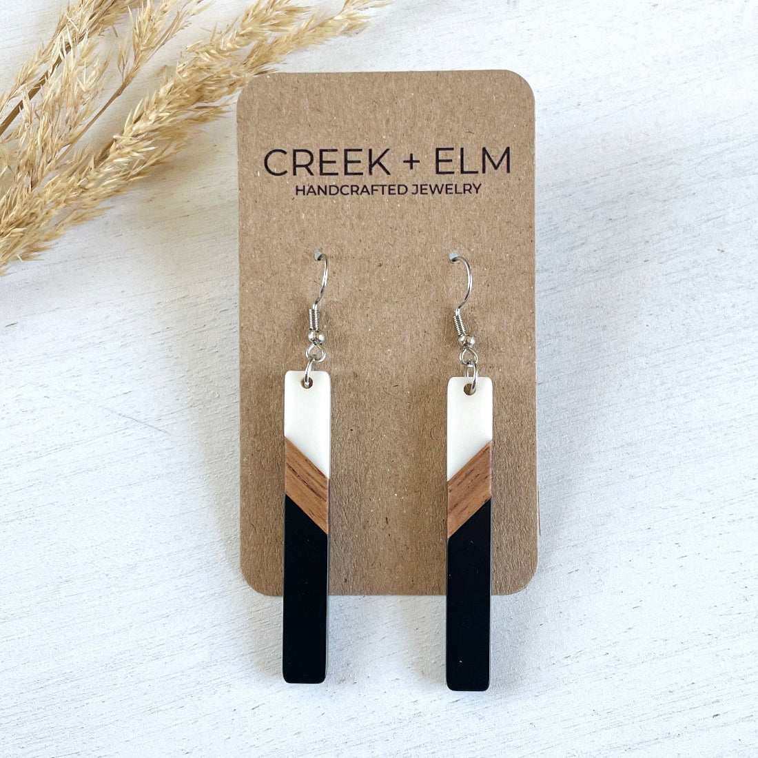 carded photo of a creek and elm tri-color earrings