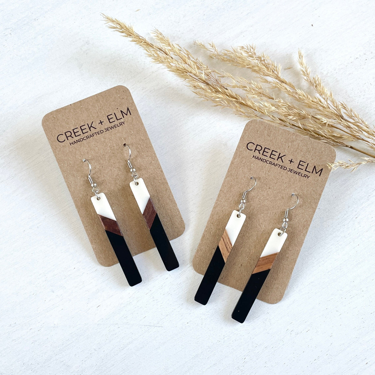 two carded tri--color earring on a white plain surface