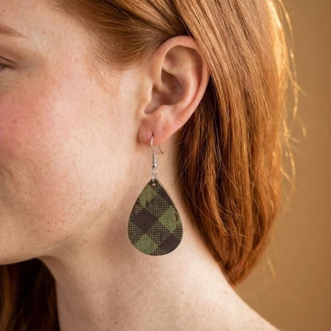 woman wearing kendra cork teardrop green buffalo plaid dangle earrings
