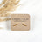 Gold stainless steel bar stud earrings on Creek + Elm packaging