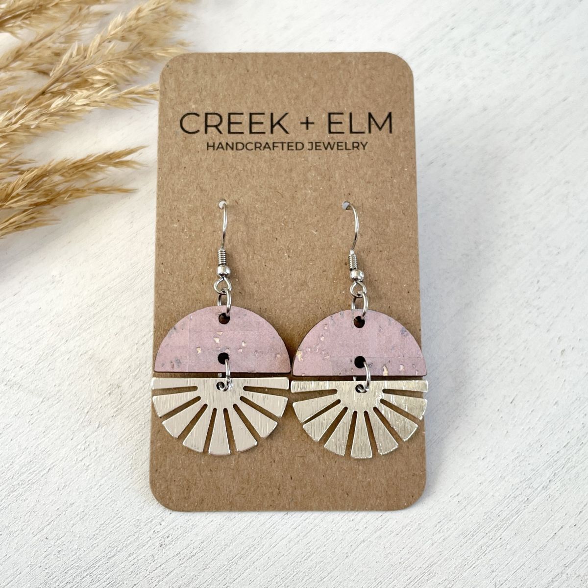 starburst swivel earrings with stainless steel detail and natural wood or cork texture