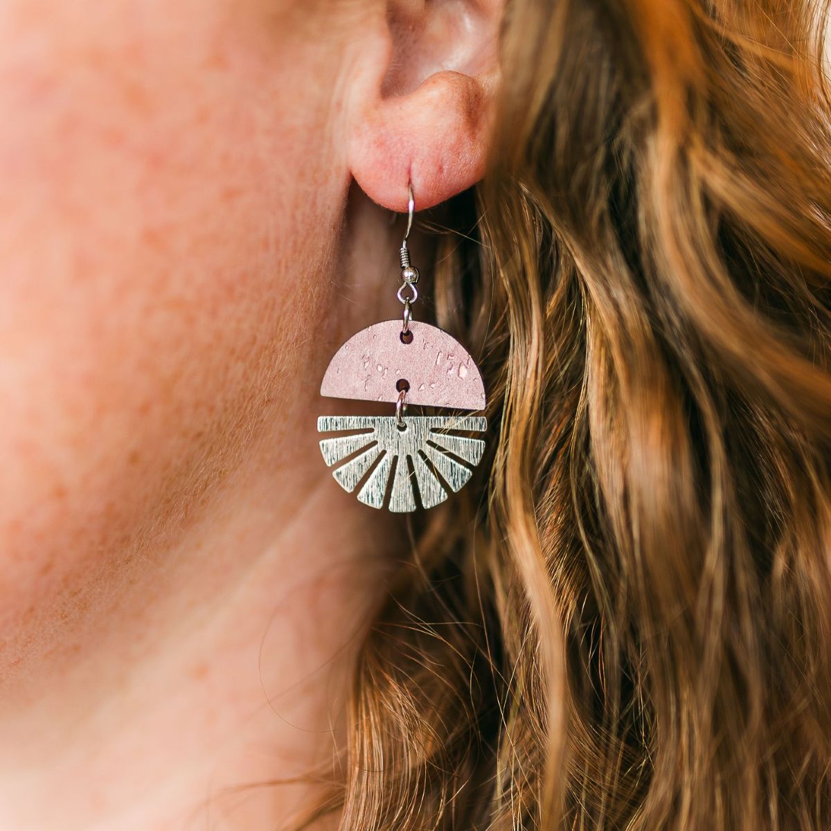 starburst swivel earrings with stainless steel detail and natural wood or cork texture