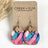 Summer sunset cork and walnut earrings with warm tones displayed on packaging