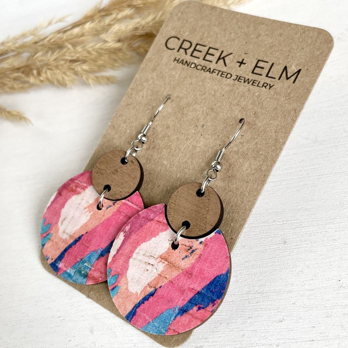Summer sunset cork and walnut earrings with warm tones displayed on packaging