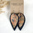 Lainey navy cork leaf earrings with floral detail and lightweight layered design on packaging