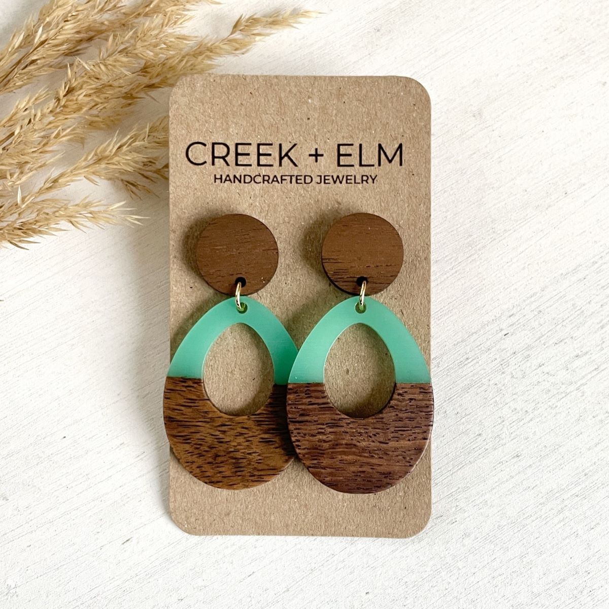 Luna seafoam wood and resin open oval earrings on packaging